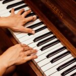 close up photo of person playing piano