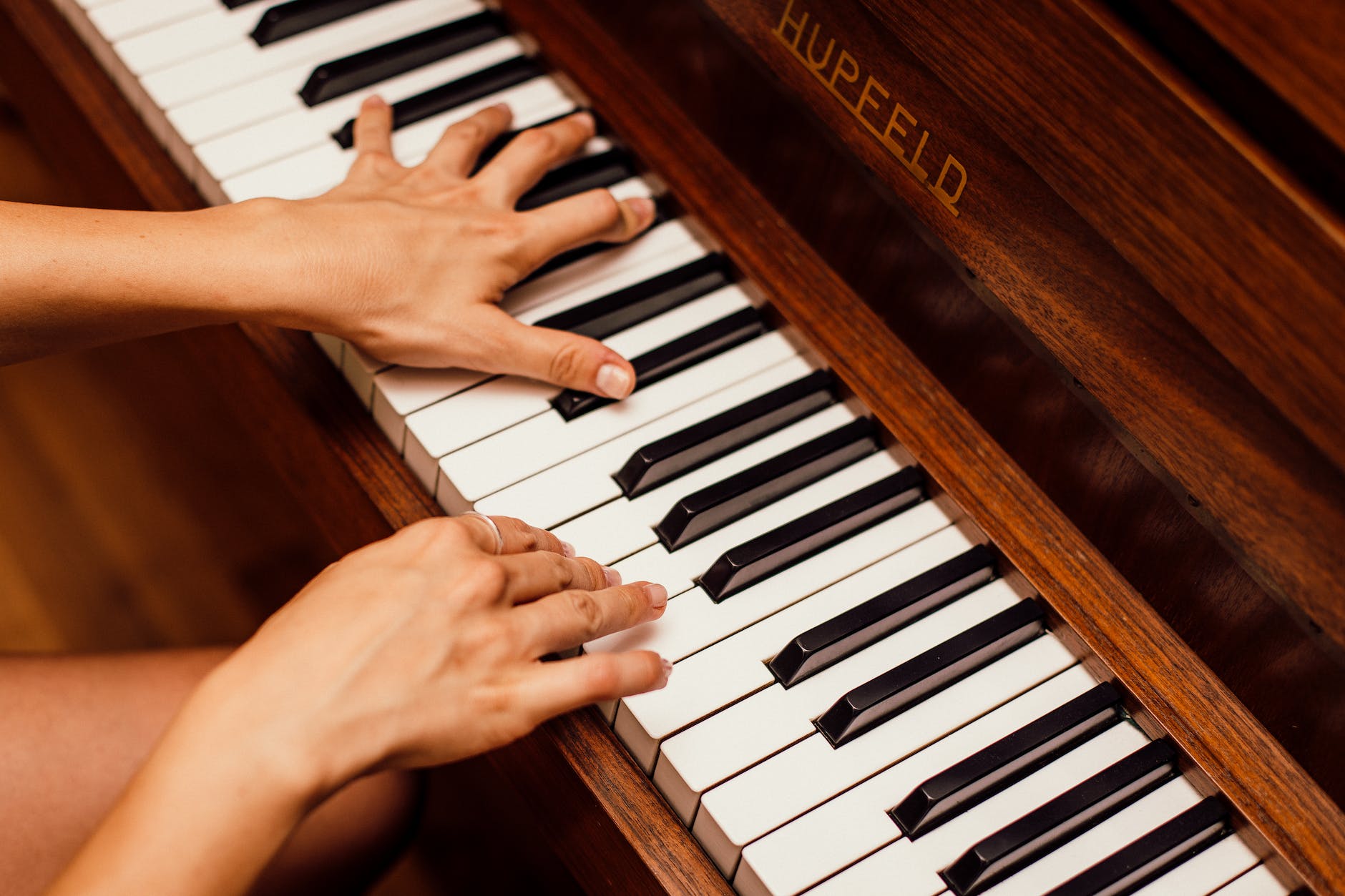 close up photo of person playing piano
