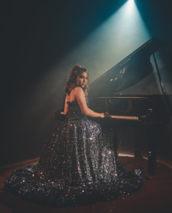 woman sitting near piano
