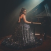 woman sitting near piano