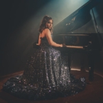 woman sitting near piano