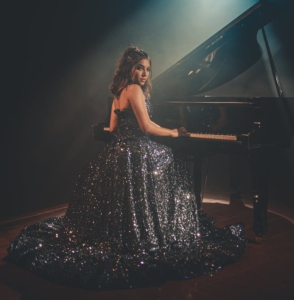 woman sitting near piano