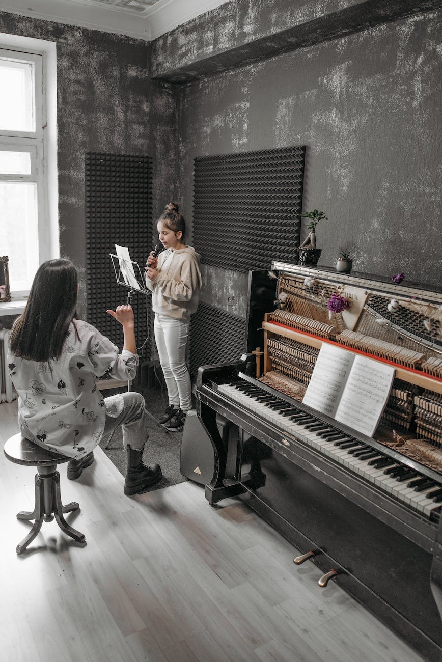 a teacher teaching a girl how to sing