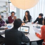 A diverse group of professionals collaborating in a modern conference room.